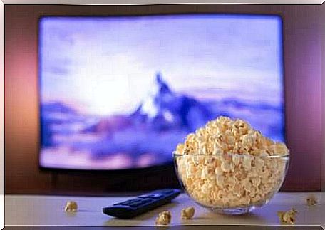 Bowl of popcorn in front of the television. 