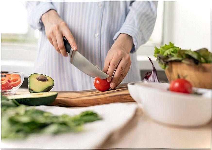 A woman preparing a salad with fresh food