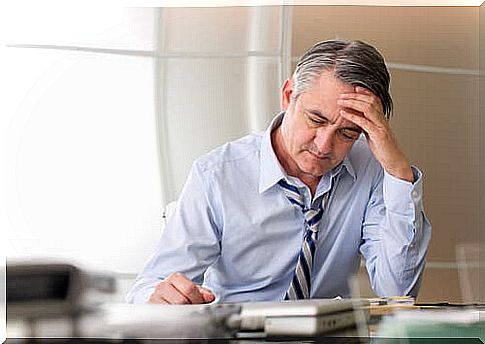 Stressed man at work having white hair